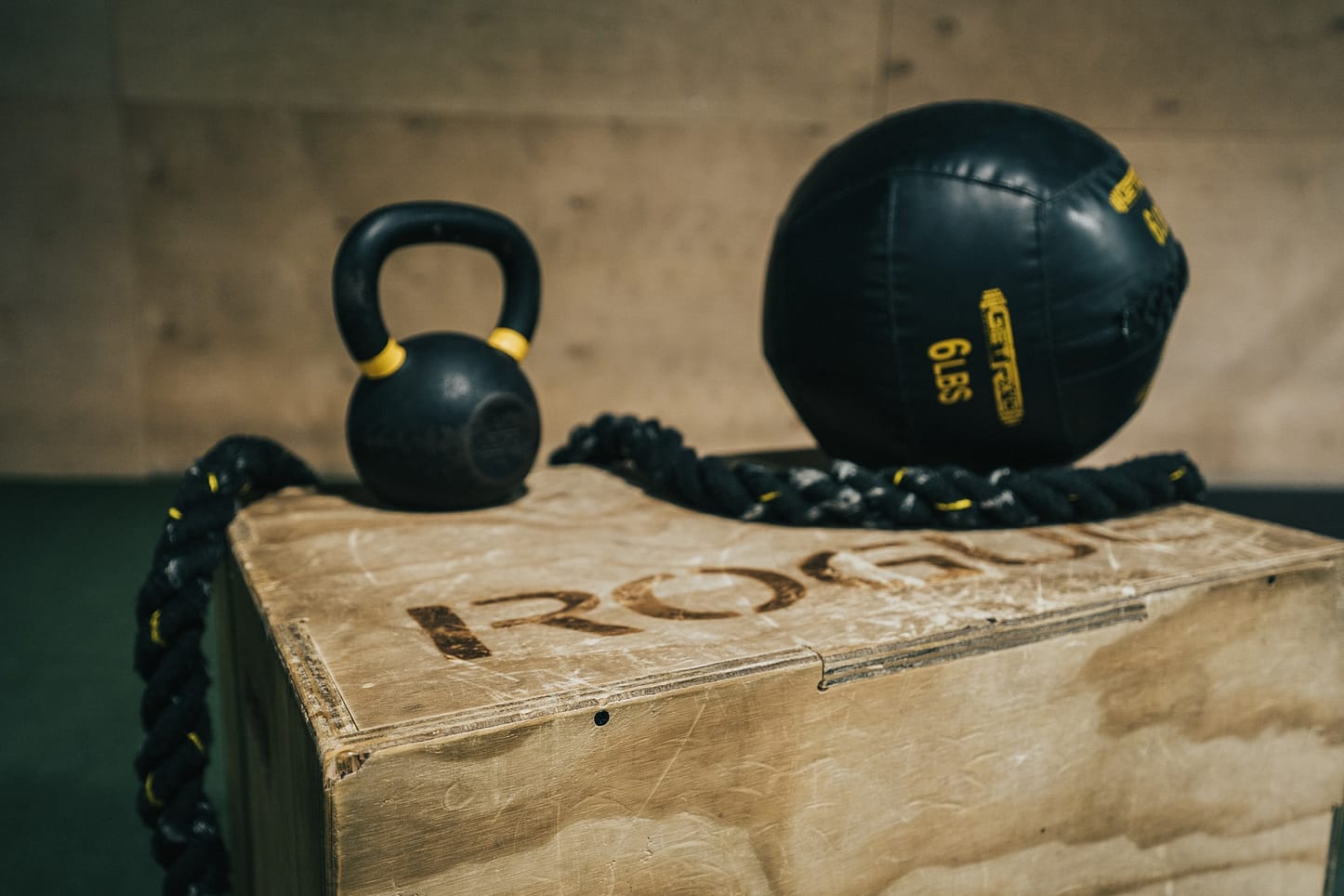 This image shows a gym with a kettlebell and a ball like you'd use for your workouts.