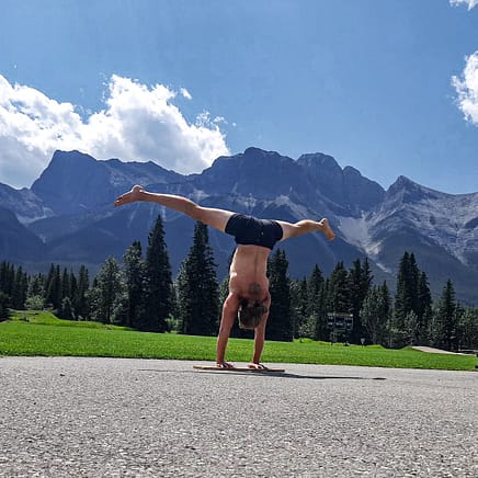 This image shows me doing a straddle handstand on a board in Canmore.