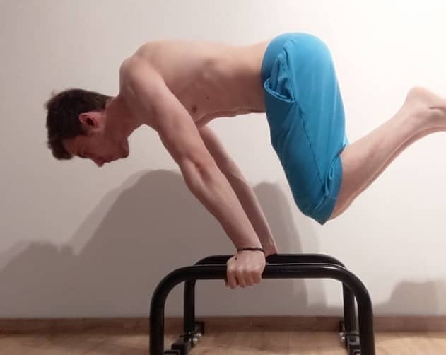 This Image shows Vladimiros from Workoutclarity performing a advanced Tuck Planche.