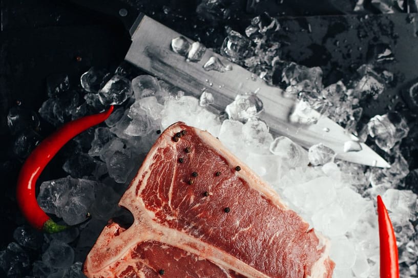 This image shows a T-bone steak on salt, a great source for protein to build lean muscles.
